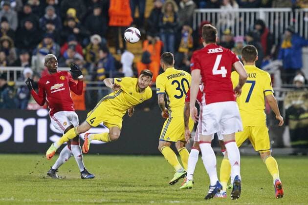 ROSTOV-ON-DON, RUSSIA - MARCH 9, 2017: FC Manchester United ManU s Paul Pogba, Phil Jones (L-R red) and FC Rostov s Vladimir Granat, Fyodor Kudryashov, Dmitry Poloz (L-R yellow) fight for the ball in Leg 1 of their 2016-17 UEFA Europa League Round of 16 football match at Olimp-2 Stadium. The game ended in a 1-1 draw. Valery Matytsin TASS  TS043C4B