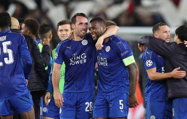Football - 2016 2017 UEFA Champions League - Round of Sixteen, Second Leg: Leicester City 1 vs. Sevilla 2 Wes Morgan of Leicester City and Christian Fuchs of Leicester City celebrate after the match at the King Power Stadium. 