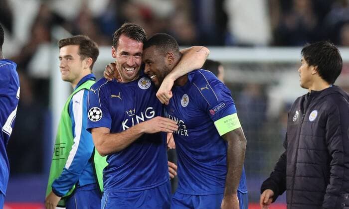 Football - 2016 2017 UEFA Champions League - Round of Sixteen, Second Leg: Leicester City 1 vs. Sevilla 2 Christian Fuchs of Leicester City and Wes Morgan of Leicester City celebrate after the match at the King Power Stadium. 