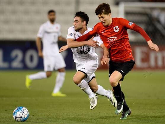 (170315) -- DOHA, March 15, 2017 -- Iranian Persepolis FC s Sadegh Moharrami Getgasari (L) vies with Qatar Rayyan s Koh Myongjin during the AFC Asian Champions League group D football match at the Jassim Bin Hamad Stadium in Doha, capital of Qatar, March 14, 2017. Qatar s Rayyan won 3-1. ) (SP)QATAR-DOHA-AFC-ASIAN CHAMPIONS LEAGUE Nikku 