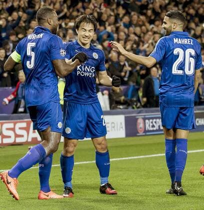 Soccer: Leicester reach Champions League q finals Wes Morgan (L) is congratulated by Leicester City teammates Shinji Okazaki (C) and Riyad Mahrez after opening the scoring in a 2-0 win at home to Sevilla in the second leg of the European Champions League round of 16 on March 14, 2017. Leicester won 3-2 on aggregate. 