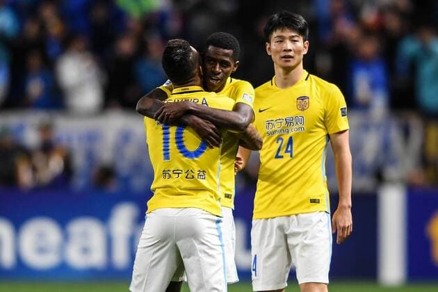 Alex Teixeira, left, and Ramires, center, of China s Jiangsu Suning celebrate after scoring a goal against Japan s Gamba Osaka in their Group H match during the AFC Champions League 2017 in Osaka, Japan, 15 March 2017. Jiangsu Suning competes against Gamba Osaka at AFC group match  20170315_62573