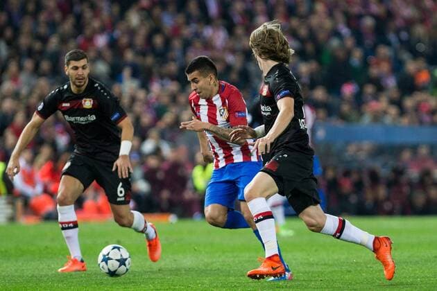 Angel Correa of Atletico de Madrid competes for the ball with Aleksandar Dragovic, Tin Jedvaj of Bayer 04 Leverkusen during the match of Uefa Champions League between Atletico de Madrid and Bayer Leverkusen at Vicente Calderon Stadium in Madrid, Spain. March 15, 2017.  (20170315014)