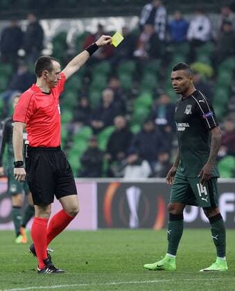 KRASNODAR, RUSSIA - MARCH 16, 2017: Chief referee Ruddy Buquet (L) shows a yellow card to FC Krasnodarâ€™s Wanderson in the 2016-17 UEFA Europa League Round of 16 Leg 2 football match against Celta de Vigo at Krasnodar Stadium. Celta de Vigo won the game 2-0. Vitaly Timkiv TASS  TS04488C