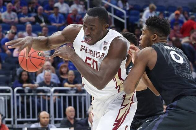 March 18, 2017 - Orlando, FL, USA - Xavier s Tyrique Jones (0) knocks the ball away from Florida State s Michael Ojo (50) in the second round of the NCAA College League USA Tournament at the Amway Center in Orlando, Fla., on Saturday, March 18, 2017. NCAA Touranment: Xavier vs. Florida State - ZUMAm67_ 20170318_zaf_m67_022 Copyright: xStephenxM.xDowellx