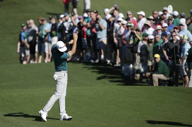 Patrons watch Dustin Johnson make a practice swing without a golf club at a practice round on Tuesday at the 2017 Masters Tournament at Augusta National Golf Club in Augusta, Georgia on April 4, 2017.  AUG20170404113 JOHNxANGELILLO