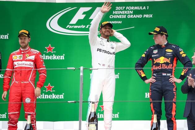 British F1 driver Lewis Hamilton of Mercedes AMG, center, waves between German F1 Sebastian Vettel of Ferrari, left, and Dutch F1 driver Max Verstappen of Red Bull Racing, right, during the award presentation ceremony of the Formula One Chinese Grand Prix at the Shanghai International Circuit in Shanghai, China, 9 April 2017. Lewis Hamilton wins 2017 Formula 1 Chinese Grand Prix  pbu604643_16