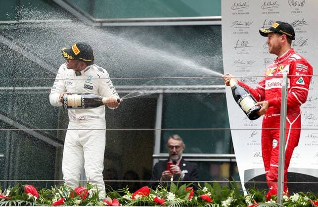 British F1 driver Lewis Hamilton of Mercedes, left, and German F1 Sebastian Vettel of Ferrari spray champagne to celebrate during the award presentation ceremony of the 2017 Formula One Chinese Grand Prix at the Shanghai International Circuit in Shanghai, China, 9 April 2017. Lewis Hamilton wins 2017 Formula 1 Chinese Grand Prix  pbu604643_21
