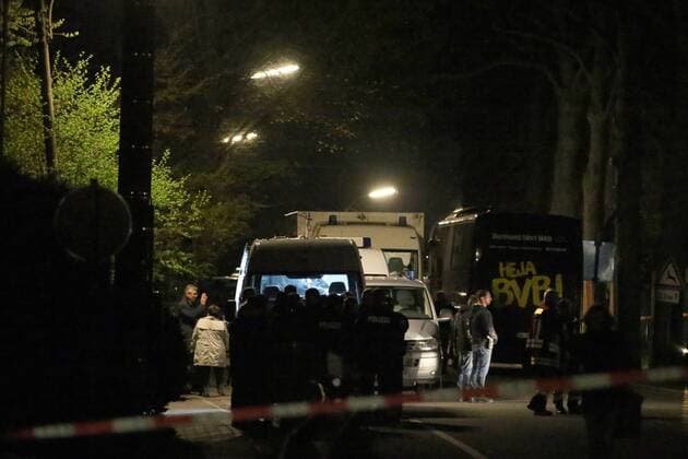 (170411) -- DORTMUND (GERMANY), April 11, 2017 -- Police officers stand guard at the site where German soccer team Dortmund s bus was damaged by explosions in Dormund, Germany, on April 11, 2017. German soccer team Dortmund said Tuesday that its Champions League match against Monaco was canceled and one player injured after explosions hit team bus. Three explosions hit Dortmund team s bus in the district of Hoechsten of the western German city of Dortmund. ) GERMANY-DORTMUND-SOCCER TEAM-BUS-EXPLOSION JoachimxBywaletz 