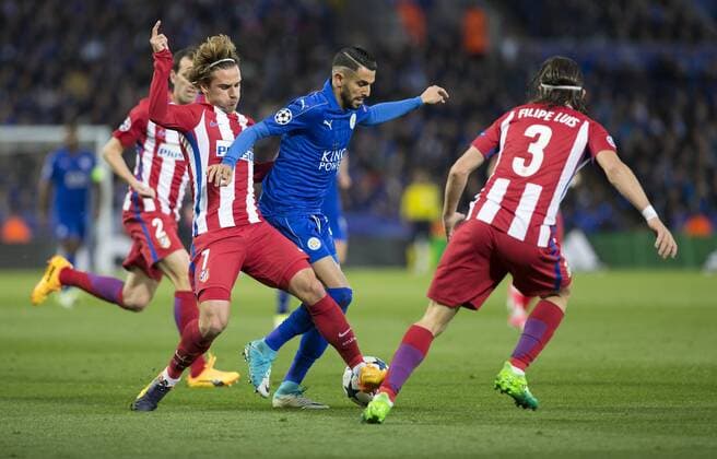 April 18th 2017, Leicester, England, UEFA Champions League football quarter-final, Leicester City versus Atletico Madrid; Antoine Griezmann of Atletico Madrid tackles Riyad Mahrez of Leicester City for the ball which leads to a free kick being awarded by Referee Gianluca Rocchi xRolandxHarrisonx  ActionPlus11869608