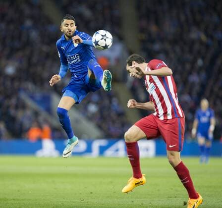 April 18th 2017, Leicester, England, UEFA Champions League football quarter-final, Leicester City versus Atletico Madrid; Riyad Mahrez of Leicester City comes in with a high boot as Diego Roberto Godin Leal of Atletico Madrid attempts to head the ball xRolandxHarrisonx  ActionPlus11869623