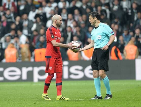 Referee Milorad Mazic and Lyon Player Christophe Jallet during the Europa league Quarter final second match between Besiktas and Lyon at the Vodafone Arena in Istanbul , Turkey April 20, 2017. 