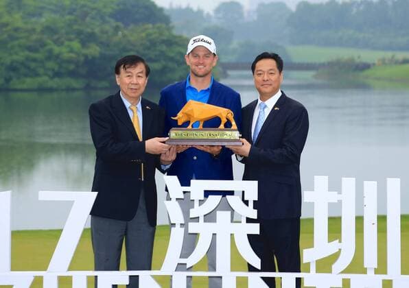 Bernd Wiesberger of Austria, center, holds his trophy after winning the 2017 Shenzhen International Golf Tournament in Shenzhen city, south China s Guangdong province, 23 April 2017. Austrian Bernd Wiesberger beat England s Tommy Fleetwood in a playoff on Sunday (23 April 2017) to win the Shenzhen International. Wiesberger went into the final round with a three-shot lead and eight shots ahead of Fleetwood but the Englishman fired a 63 to finish tied at 16 under. Wiesberger s 71 featured par saves on the 12th and 17th and he nearly hit the pin with his approach to the last hole but was forced to settle for a par and a trip back up the 18th. Wiesberger hit his drive in the playoff over the water off the tee and ended up in the bank while Fleetwood played safely onto the fairway and found the heart of the green with his second shot. The pressure was on Wiesberger and he delivered, placing his approach to five feet and making the putt for a birdie. Bubba Watson takes the lead at 2017 Shenzhen International  20170423_50989