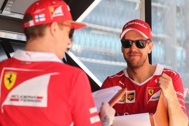 SOCHI, RUSSIA - APRIL 27, 2017: German racing driver Sebastian Vettel (R) of the Scuderia Ferrari F1 team seen ahead of free practice session of the 2017 Formula One Russian Grand Prix at the Sochi Autodrom racing circuit. Vyacheslav Prokofyev TASS  TS049CE0