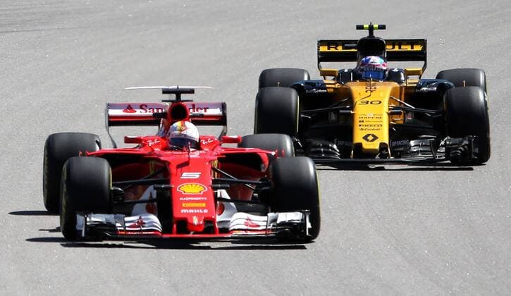 SOCHI, RUSSIA - APRIL 28, 2017: German racing driver Sebastian Vettel (L) of the Scuderia Ferrari F1 team and British driver Jolyon Palmer of the Renault Formula 1 team take part in a practice session ahead of the 2017 Formula One VTB Russian Grand Prix at the Sochi Autodrom racing circuit. Alexander Demianchuk TASS  TS049FA1
