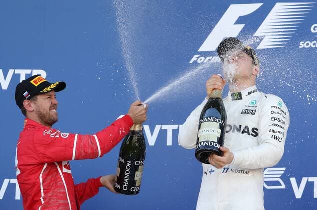 SOCHI, RUSSIA - APRIL 30, 2017: Second-placed Scuderia Ferrari F1 driver Sebastian Vettel (L) of Germany and first-placed Mercedes AMG Petronas F1 driver Valtteri Bottas of Finland spray champagne on the podium after the 2017 Formula One Russian Grand Prix at the Sochi Autodrom racing circuit. Vyacheslav Prokofyev TASS  TS04A3A1