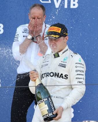 SOCHI, RUSSIA - APRIL 30, 2017: Mercedes Race Engineer Tony Ross (L) looks on as frst-placed Mercedes AMG Petronas F1 driver Valtteri Bottas sprays champagne on the podium after the 2017 Formula One Russian Grand Prix at the Sochi Autodrom racing circuit. Vyacheslav Prokofyev TASS  TS04A3A9