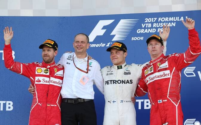 SOCHI, RUSSIA - APRIL 30, 2017: Second-placed Scuderia Ferrari F1 driver Sebastian Vettel of Germany, Mercedes Race Engineer Tony Ross, and first-placed Mercedes AMG Petronas F1 driver Valtteri Bottas of Finland, and third-placed Scuderia Ferrari F1 Team driver Kimi Raikkonen of Finland (L-R) pose for a group photo on the podium after the 2017 Formula One Russian Grand Prix at the Sochi Autodrom racing circuit. Vyacheslav Prokofyev TASS  TS04A3AB