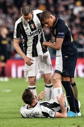 May 9, 2017 - Rome, Italy - Kylian Mbapp of Monaco helps Andrea Barzagli of Juventus during the UEFA Champions League Semi-Final game 2 match between Juventus and Monaco at the Juventus Stadium, Turin, Italy on 9 May 2017. Juventus - Monaco Champions League Semi-Final  - ZUMAn230 20170509_zaa_n230_313 Copyright: xGiuseppexMaffiax