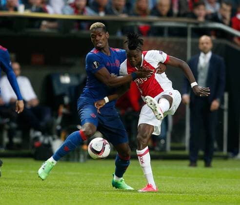 Paul Pogba of Manchester United ManU in action with Bertrand Traore of Ajax during the UEFA Europa League Final match at the Friends Arena, Stockholm. Picture date: May 24th, 2017.Picture credit should read: Matt McNulty Sportimage EDITORIAL USE ONLY. No use with unauthorised audio, video, data, fixture lists, club league logos or live services. Online in-match use limited to 120 images, no video emulation. No use in betting, games or single club league player publications.