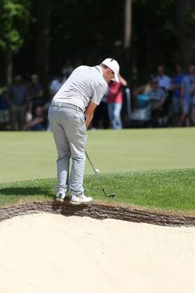 May 25th 2017, Virginia Water, Wentworth, Surrey, England; BMW PGA Golf Herren Championship golf, day 1; Matthew Fitzpatrick chips forward as balanced precarious on the edge of green side bunker at 15th xDavidxKissmanx  ActionPlus11883369