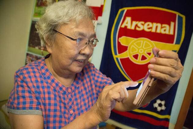 BEIJING, CHINA - MAY 28: 78-year-old gooner Liu Hongwen writes a Weibo after Arsenal winning the FA Cup Final at home on May 28, 2017 in Beijing, China. 78-year-old retired teacher Liu Hongwen became an Arsenal fan in 2002. On Liu s 75 birthday, her son registered a Sina Weibo account for her. She supports Arsenal on Weibo and becomes a web celebrity with a nickname Gooner Granny Liu .  Copyright: xVCGx CFP111103650450 