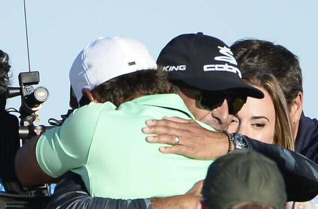 Brooks Koepka is hugged after winning the 117th U.S. Open golf tournament at Erin Hills golf course on June 18, 2017, in Erin, Wisconsin. Koepka posted a final score of 16-under-par.  WIS20170618581 BRIANxKERSEY