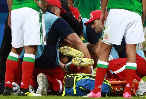 SOCHI, RUSSIA â€“ JUNE 21, 2017: Mexico s injured Carlos Salcedo receives medical aid during the 2017 FIFA Confederations Cup Group A match against New Zealand at Fisht Stadium. Sergei Fadeichev TASS  TS05418D