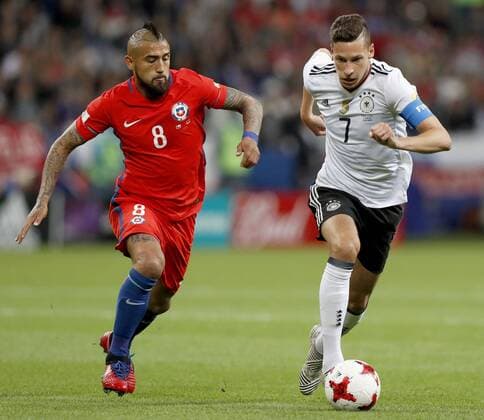 Soccer: Chile, Germany draw 1-1 Chile midfielder Arturo Vidal (L) chases Germany s Julian Draxler during the first half of a Group B match of the FIFA Confederations Cup in Kazan, Russia, on June 22, 2017. Chile and Germany drew 1-1. 