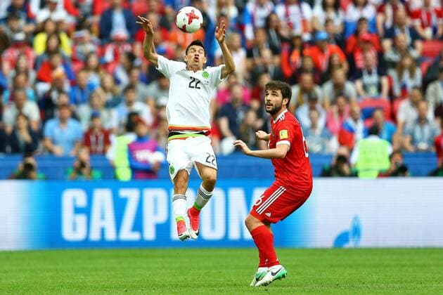 Mexico vs. Russia SAO PETERSBURGO, MO - 24.06.2017: MEXICO VS. RUSSIA - Hirving Lozano of Mexico contests a bid with Dzhikya Georgy of Russia during a match between Mexico and Russia valid for the third round of the Confederations Cup 2017 on Saturday (24) held at the Kazan Arena in Kazan, Russia. (Photo: Heuler Andrey DiaEsportivo Fotoarena) x1343485x  HeulerxAndrey