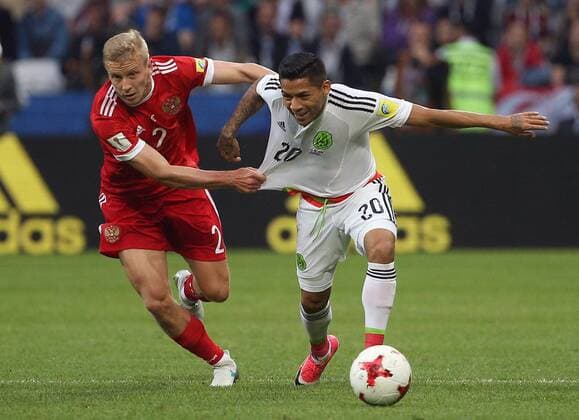 KAZAN, RUSSIA - JUNE 24, 2017: Russia s Igor Smolnikov (L), and Mexico s Javier Aquino in action in their 2017 FIFA Confederations Cup First Stage Group A football match at Kazan Arena Stadium; Mexico won the game 2-1. Yegor Aleyev TASS  TS054A46