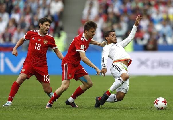 Mexico vs. Russia SAO PETERSBURGO, MO - 24.06.2017: MEXICO VS. RUSSIA - Yury ZHIRKOV and Aleksandr GOLOVIN of Russia play the ball with DOS SANTOS Jonathan of Mexico during a match between Mexico and Russia valid for the third round of the Confederations Cup 2017 on Saturday (24) held at Kazan Arena Stadium in Kazan, Russia. (Photo: Rodolfo Buhrer La Imagem Fotoarena) x1343668x  RodolfoxBuhrer