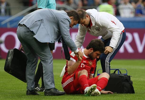 KAZAN, RUSSIA - JUNE 24, 2017: Russia s Georgy Dzhikiya (C sitting) sustains an injury in their 2017 FIFA Confederations Cup First Stage Group A football match at Kazan Arena Stadium; Mexico won the game 2-1. Yegor Aleyev TASS  TS054A41