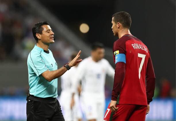 KAZAN, RUSSIA - JUNE 28, 2017: Portugal s Cristiano Ronaldo (R) talks to referee Alireza Faghani during the 2017 FIFA Confederations Cup semifinal football match against Chile at Kazan Arena Stadium. Stanislav Krasilnikov TASS  TS05549C