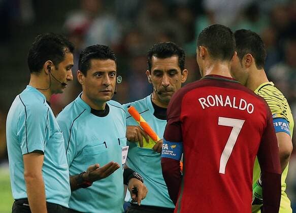 KAZAN, RUSSIA â€“ JUNE 28, 2017: Referee Alireza Faghani (2nd L) talks to Chile s goalkeeper Claudio Bravo and Portugal s Cristiano Ronaldo (R-L) in their 2017 FIFA Confederations Cup semifinal football match at Kazan Arena Stadium. The game ended in a 0-0 draw. Chile won 3-0 on penalties after extra time. Yegor Aleyev TASS  TS055505