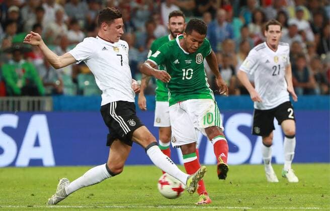 SOCHI, RUSSIA - JUNE 29, 2017: Germany s Julian Draxler (L) and Mexico s Giovani dos Santos fight for the ball in their 2017 FIFA Confederations Cup semifinal football match at Fisht Stadium. Sergei Fadeichev TASS  TS0557F0