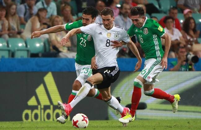 SOCHI, RUSSIA - JUNE 29, 2017: Mexico s Oswaldo Alanis, Germany s Leon Goretzka, and Mexico s Hector Herrera (L-R) fight for the ball in their 2017 FIFA Confederations Cup semifinal football match at Fisht Stadium. Sergei Fadeichev TASS  TS055827