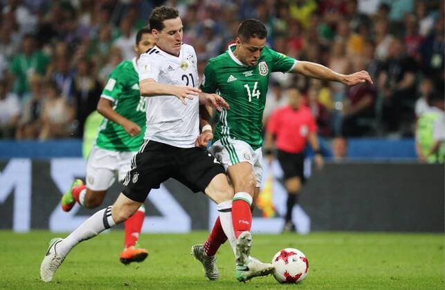SOCHI, RUSSIA - JUNE 29, 2017: Germany s Sebastian Rudy (L) and Mexico s Javier Hernandez fight for the ball in their 2017 FIFA Confederations Cup semifinal football match at Fisht Stadium. Germany won the game 4-1. Artyom Korotayev TASS  TS055839