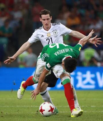 SOCHI, RUSSIA - JUNE 29, 2017: Germany s Sebastian Rudy (back) and Mexico s Hector Herrera (front) fight for the ball in their 2017 FIFA Confederations Cup semifinal football match at Fisht Stadium. Germany won the game 4-1. Sergei Fadeichev TASS  TS055859