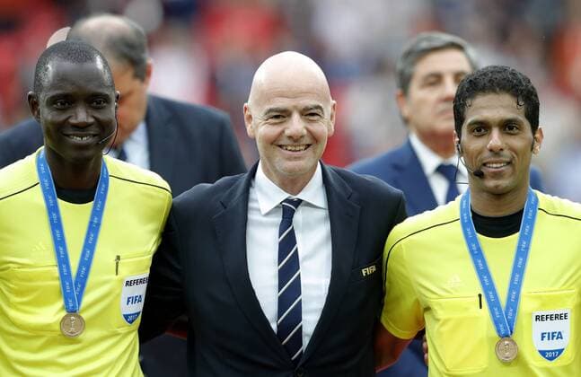 MOSCOW, RUSSIA â€“ JULY 2, 2017: Referees Bakary Papa Gassama (L), Fahad Al-Mirdasi (R) pose for a photo with FIFA President Gianni Infantino (C) after the 2017 FIFA Confederations Cup third place football match between Portugal and Mexico at Spartak Stadium. Portugal won the game 2-1 in extra time and claimed bronze medals. Mikhail Japaridze TASS  TS055CC2