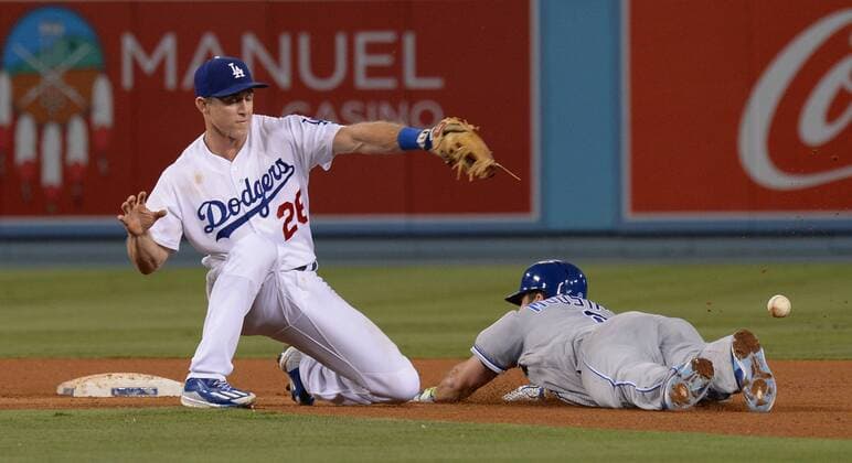 Kansas City Royals Mike Moustakis is safe for a double in the fourth inning as the ball gets past 2nd baseman Chase Utley when the throw from Los Angeles Dodgers right fielder Yasiel Puig deflected off Moustakis legs at Dodger Stadium in Los Angeles on July 7, 2017. The Dodgers defeated the Royals 4-1.  LAP2017070711 JIMxRUYMEN