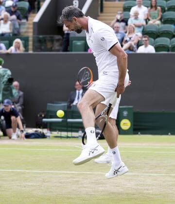 July 13th 2017, All England Lawn Tennis and Croquet Club, London, England; The Wimbledon Tennis Championships, Day 10; Goran Ivanisevic (CRO) hits the ball through his legs during his match with Wayne Ferreira (RSA) against Jeremy Bates (GBR) and Chris Wilkinson (GBR) xRolandxHarrisonx  ActionPlus11900793