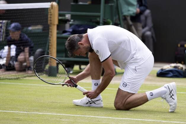 July 13th 2017, All England Lawn Tennis and Croquet Club, London, England; The Wimbledon Tennis Championships, Day 10; Goran Ivanisevic (CRO) crouches low during a serve in his match with Wayne Ferreira (RSA) against Jeremy Bates (GBR) and Chris Wilkinson (GBR) xRolandxHarrisonx  ActionPlus11900797