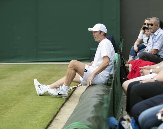 July 13th 2017, All England Lawn Tennis and Croquet Club, London, England; The Wimbledon Tennis Championships, Day 10; Jeremy Bates (GBR) sits down on the rain covers during a rally in his match with Chris Wilkinson (GBR) against Goran Ivanisevic (CRO) and Wayne Ferreira (RSA) xRolandxHarrisonx  ActionPlus11900803