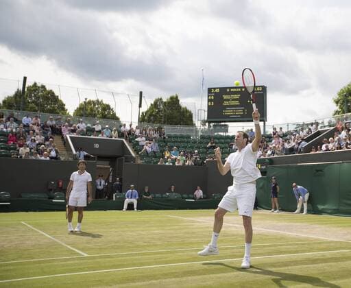 July 13th 2017, All England Lawn Tennis and Croquet Club, London, England; The Wimbledon Tennis Championships, Day 10; Greg Rusedski (GBR) hits a forehand smash during his match with Fabrice Santoro (FRA) against Monsour Bahrami (IRI) and Michael Llordra (FRA) xRolandxHarrisonx  ActionPlus11900832