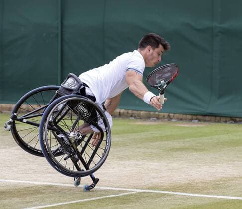 July 14th 2017, All England Lawn Tennis and Croquet Club, London, England; The Wimbledon Tennis Championships, Day 11; Gustavo Fernandez (ARG) falling forward on to the grass after attempting a backhand return to Alfie Hewett (GBR) xRolandxHarrisonx  ActionPlus11901324