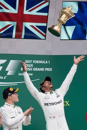 July 16th 2017, Silverstone, Northamptonshire, England; British Formula 1 Grand Prix, Race Day; Mercedes AMG Petronas Motorsport driver Lewis Hamilton throws the winners trophy into the air on the podium xTimxWilliamsx  ActionPlus11902599