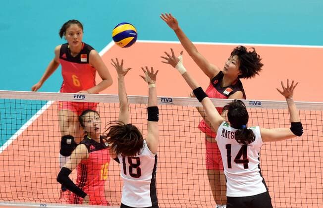 Yuan Xinyue, right, of China spikes against Mami Uchiseto, and Ayaka Matsumoto of Japan during the Pool G1-Group 1 match of the FIVB Volleyball World Grand Prix Hong Kong 2017 in Hong Kong, China, 21 July 2017. China defeated Japan 3-1 (25-19, 25-20, 33-35, 25-21). China defeats Japan during FIVB Volleyball World Grand Prix Hong Kong 2017  pbu656153_10