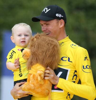 Chris Froome of Great Britain holds his son Kellan after winning the Tour de France in Paris on July 23, 2017. Froome claimed his fourth Tour de France victory.  PAR20170723027 DAVIDxSILPA