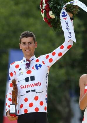 Warren Barguil of France celebrates on the presentation podium after winning the polka dot jersey (best climber) at the Tour de France in Paris on on July 23, 2017.  PAR20170723021 DAVIDxSILPA